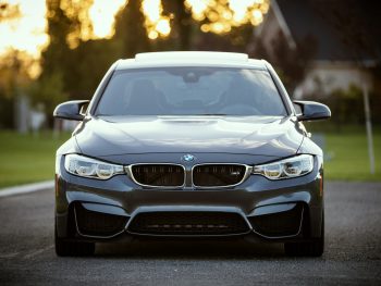 black BMW car surrounded by grass field