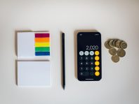 black iphone 4 beside black and silver remote control