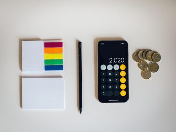 black iphone 4 beside black and silver remote control