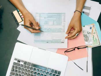 person writing on white paper