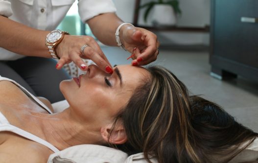 person holding woman nose