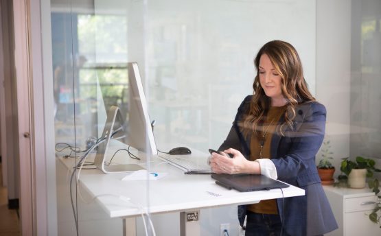 woman in black leather jacket using macbook air